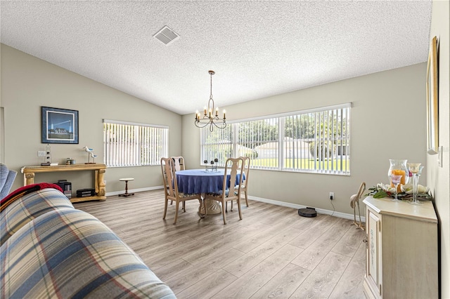 9266 SW 91st Cir, Ocala, FL 34481 - dining space featuring a chandelier, light wood finished floors, a textured ceiling, lofted ceiling, and baseboards
