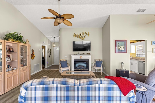 9266 SW 91st Cir, Ocala, FL 34481 - living room featuring ceiling fan, lofted ceiling, wood finished floors, a glass covered fireplace, and baseboards