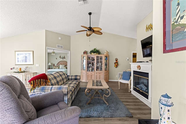 9266 SW 91st Cir, Ocala, FL 34481 - living area with a ceiling fan, lofted ceiling, wood finished floors, a glass covered fireplace, and a textured ceiling