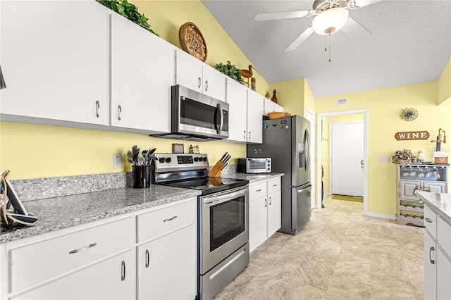 9266 SW 91st Cir, Ocala, FL 34481 - kitchen with stainless steel appliances, white cabinetry, a ceiling fan, a textured ceiling, and light stone countertops