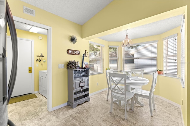 9266 SW 91st Cir, Ocala, FL 34481 - dining area with a chandelier, baseboards, a textured ceiling, and washer / dryer