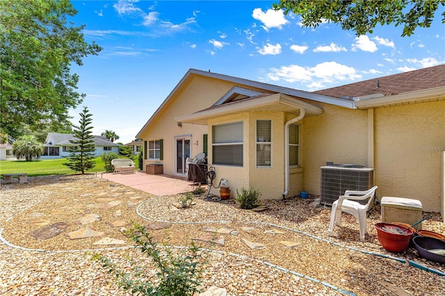 9266 SW 91st Cir, Ocala, FL 34481 - rear view of house featuring central air condition unit, stucco siding, and a patio area