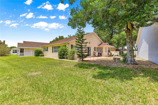 9266 SW 91st Cir, Ocala, FL 34481 - rear view of property with stucco siding, a lawn, and a patio area