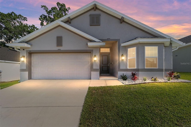 181 NW 45th Loop, Ocala, FL 34475 - view of front facade featuring stucco siding, driveway, an attached garage, and a yard