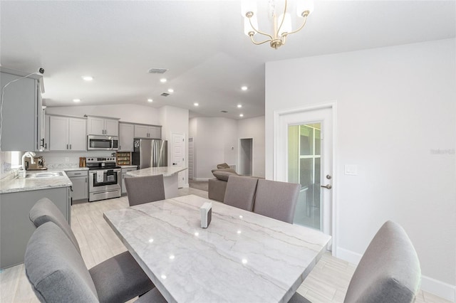 181 NW 45th Loop, Ocala, FL 34475 - dining room with vaulted ceiling, a chandelier, baseboards, recessed lighting, and light wood-style flooring