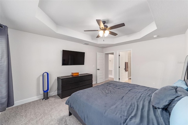 181 NW 45th Loop, Ocala, FL 34475 - bedroom featuring a tray ceiling, baseboards, light carpet, and a ceiling fan