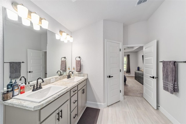 181 NW 45th Loop, Ocala, FL 34475 - ensuite bathroom with baseboards and double vanity