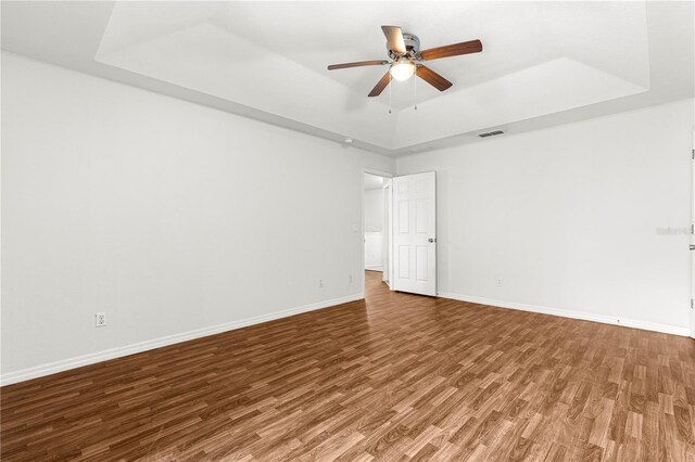10016 SW 62nd Cir, Ocala, FL 34476 - empty room featuring a raised ceiling, wood finished floors, a ceiling fan, and baseboards