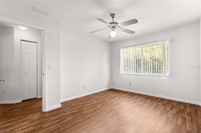 10016 SW 62nd Cir, Ocala, FL 34476 - unfurnished room with wood finished floors, baseboards, and a ceiling fan