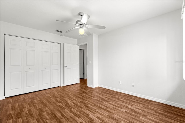 10016 SW 62nd Cir, Ocala, FL 34476 - unfurnished bedroom with wood finished floors, baseboards, a closet, and a ceiling fan