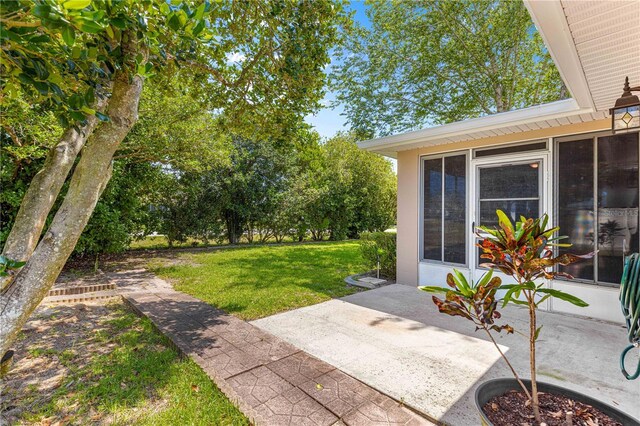 10016 SW 62nd Cir, Ocala, FL 34476 - view of green lawn with a patio and a sunroom