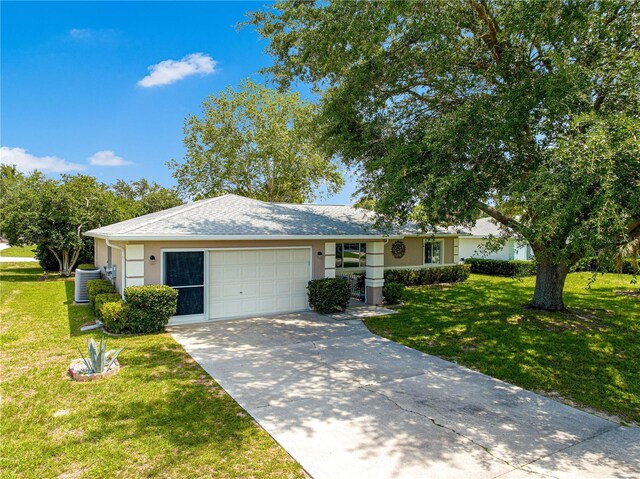 10016 SW 62nd Cir, Ocala, FL 34476 - ranch-style home featuring an attached garage, cooling unit, stucco siding, and a front lawn