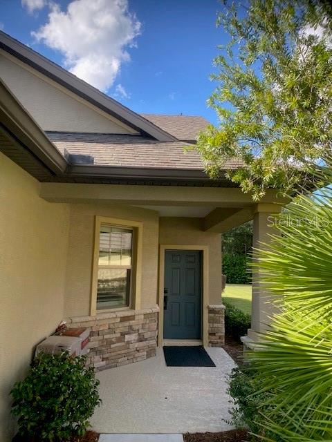 9170 SW 65th Loop, Ocala, FL 34481 - doorway to property featuring stucco siding and stone siding