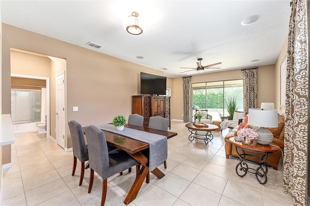9170 SW 65th Loop, Ocala, FL 34481 - dining space featuring light tile patterned floors, ceiling fan, baseboards, and a textured ceiling