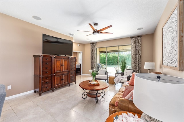 9170 SW 65th Loop, Ocala, FL 34481 - living room featuring a ceiling fan, baseboards, and light tile patterned floors