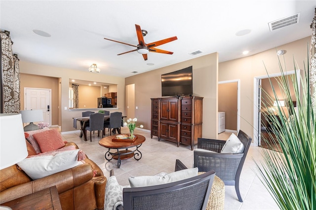 9170 SW 65th Loop, Ocala, FL 34481 - living room featuring light tile patterned floors, ceiling fan, and baseboards