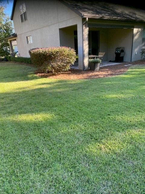 9170 SW 65th Loop, Ocala, FL 34481 - view of side of property with a lawn