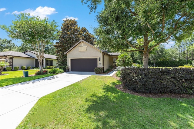 9170 SW 65th Loop, Ocala, FL 34481 - view of front facade featuring an attached garage, driveway, a front lawn, stucco siding, and stone siding