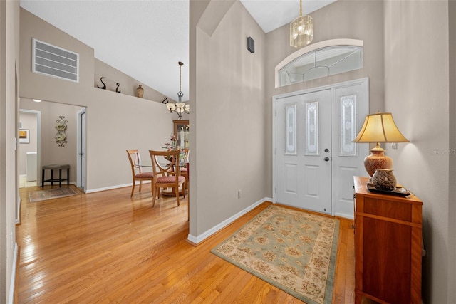 11147 SW 53rd Cir, Ocala, FL 34476 - entrance foyer featuring high vaulted ceiling, a chandelier, light wood-style flooring, and baseboards