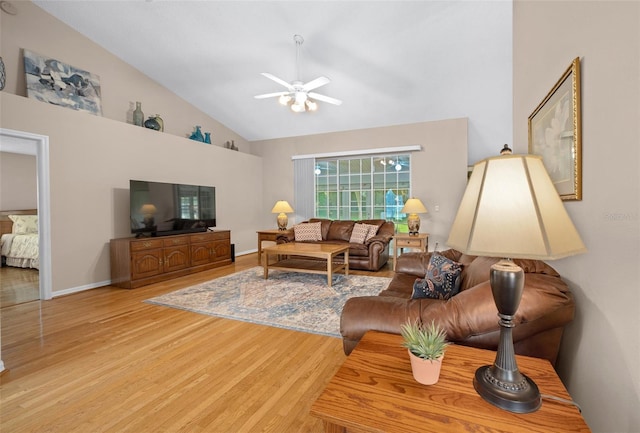 11147 SW 53rd Cir, Ocala, FL 34476 - living room featuring light wood-style floors, ceiling fan, high vaulted ceiling, and baseboards
