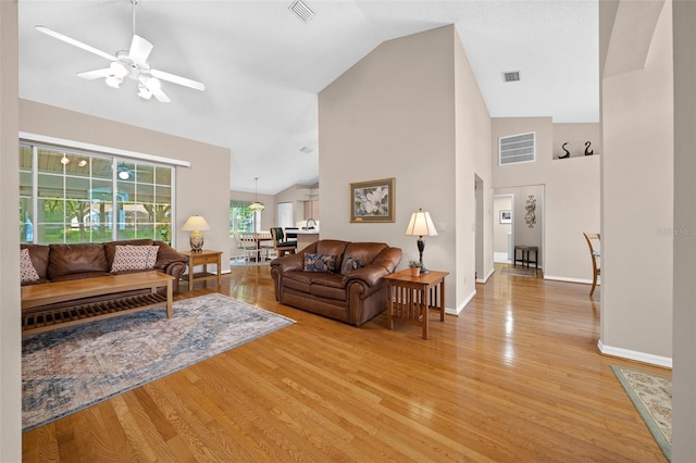 11147 SW 53rd Cir, Ocala, FL 34476 - living room with light wood-type flooring, ceiling fan, baseboards, and high vaulted ceiling