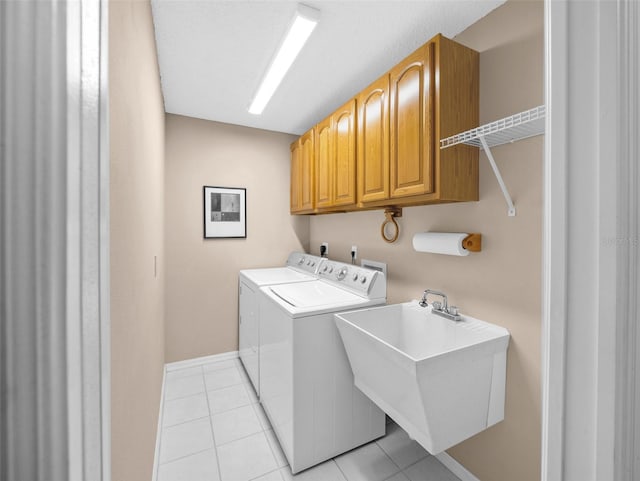 11147 SW 53rd Cir, Ocala, FL 34476 - washroom featuring light tile patterned floors, washer and clothes dryer, cabinet space, and baseboards