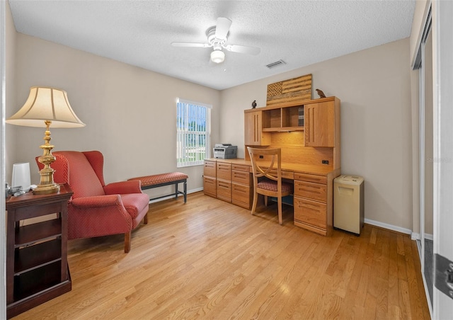 11147 SW 53rd Cir, Ocala, FL 34476 - office featuring light wood-style flooring, a ceiling fan, baseboards, and a textured ceiling