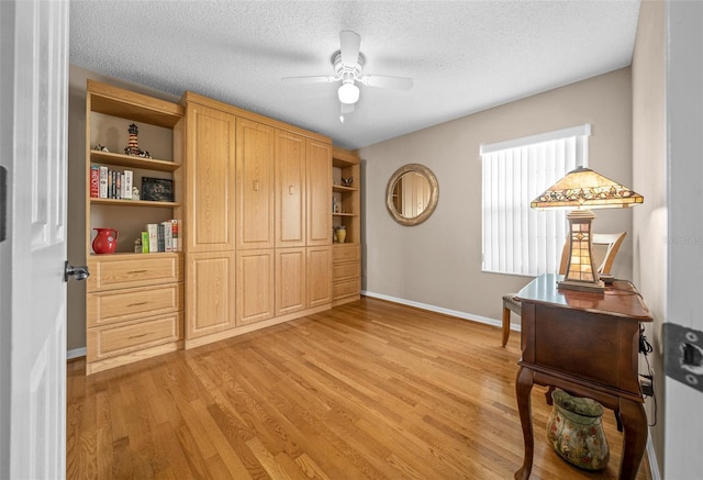 11147 SW 53rd Cir, Ocala, FL 34476 - home office with light wood finished floors, a ceiling fan, baseboards, and a textured ceiling