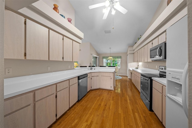 11147 SW 53rd Cir, Ocala, FL 34476 - kitchen featuring stainless steel appliances, a peninsula, light brown cabinetry, light wood-style flooring, and vaulted ceiling