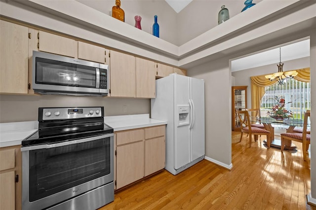 11147 SW 53rd Cir, Ocala, FL 34476 - kitchen featuring appliances with stainless steel finishes, a chandelier, light wood-style flooring, light countertops, and light brown cabinets