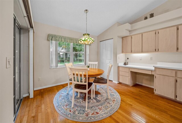 11147 SW 53rd Cir, Ocala, FL 34476 - dining room featuring vaulted ceiling, light wood-type flooring, and baseboards