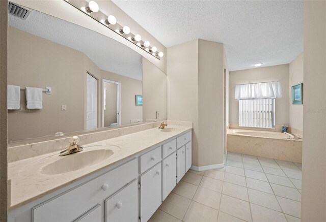 11147 SW 53rd Cir, Ocala, FL 34476 - full bath featuring tile patterned floors, double vanity, a bath, and a textured ceiling