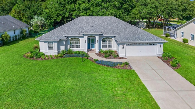 11147 SW 53rd Cir, Ocala, FL 34476 - view of front of home with an attached garage, a shingled roof, a front yard, and driveway