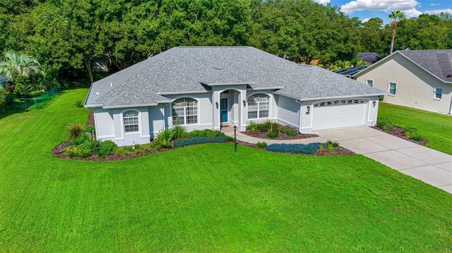 11147 SW 53rd Cir, Ocala, FL 34476 - ranch-style house featuring a garage, a front lawn, concrete driveway, and a shingled roof
