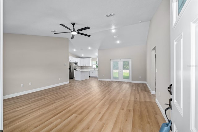 8293 SE 158th St, Summerfield, FL 34491 - unfurnished living room with vaulted ceiling, a ceiling fan, baseboards, and light wood-style flooring