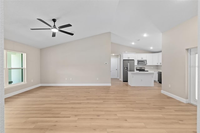 8293 SE 158th St, Summerfield, FL 34491 - unfurnished living room featuring lofted ceiling, a ceiling fan, baseboards, light wood finished floors, and recessed lighting