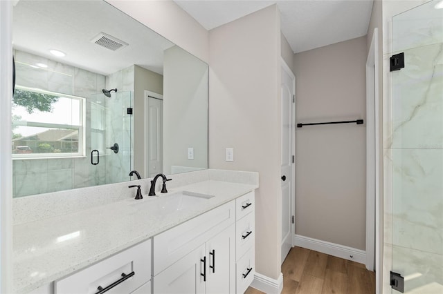 8293 SE 158th St, Summerfield, FL 34491 - full bath featuring a marble finish shower, vanity, wood finished floors, and baseboards