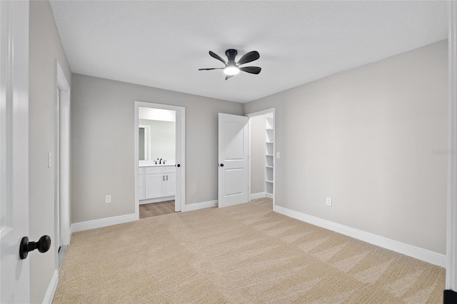 8293 SE 158th St, Summerfield, FL 34491 - unfurnished bedroom featuring carpet, baseboards, connected bathroom, and a ceiling fan