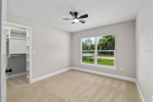 8293 SE 158th St, Summerfield, FL 34491 - unfurnished bedroom with carpet, a spacious closet, baseboards, and a textured ceiling