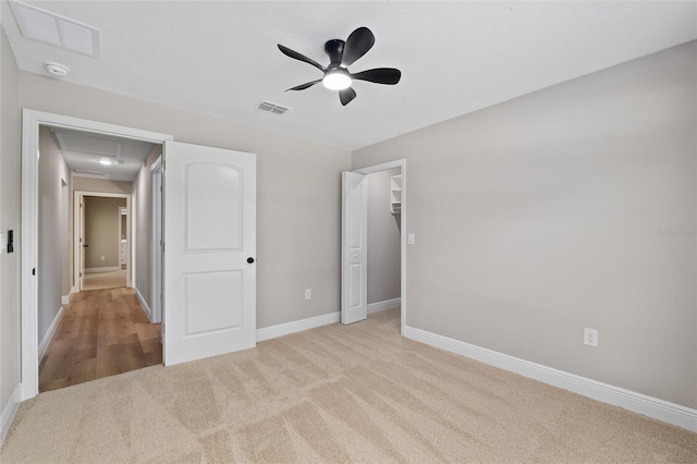 8293 SE 158th St, Summerfield, FL 34491 - unfurnished bedroom featuring carpet floors, attic access, baseboards, ceiling fan, and a spacious closet