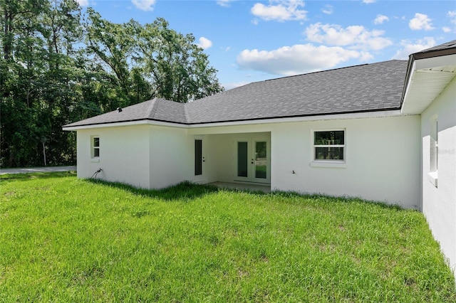 8293 SE 158th St, Summerfield, FL 34491 - back of house featuring roof with shingles, a lawn, french doors, and stucco siding