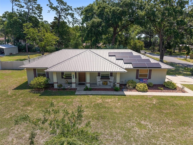 1601 NE 47th Ct, Ocala, FL 34470 - view of front of home with a porch, stucco siding, roof mounted solar panels, and metal roof