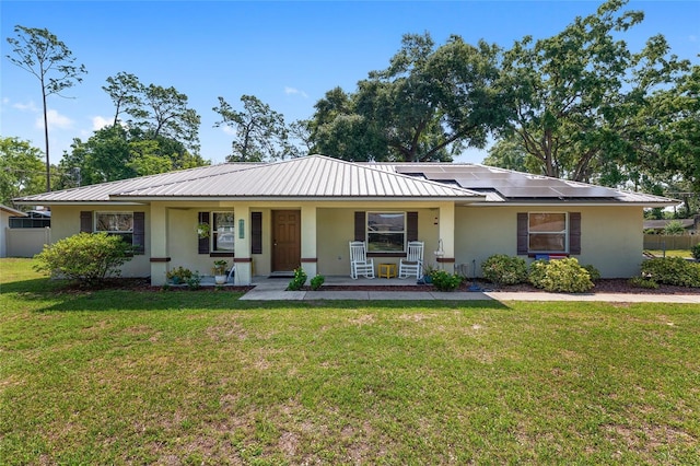 1601 NE 47th Ct, Ocala, FL 34470 - ranch-style home featuring covered porch, stucco siding, solar panels, and metal roof