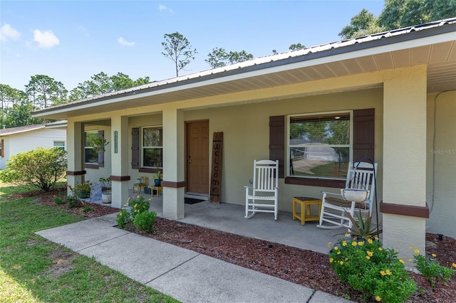 1601 NE 47th Ct, Ocala, FL 34470 - entrance to property with covered porch, stucco siding, and metal roof