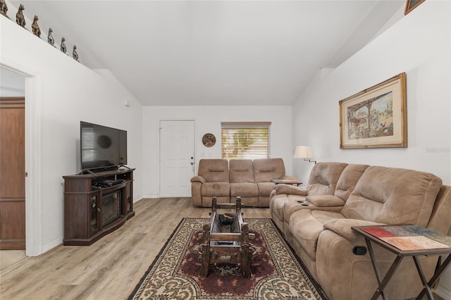 1601 NE 47th Ct, Ocala, FL 34470 - living room with light wood-style flooring, lofted ceiling, and baseboards