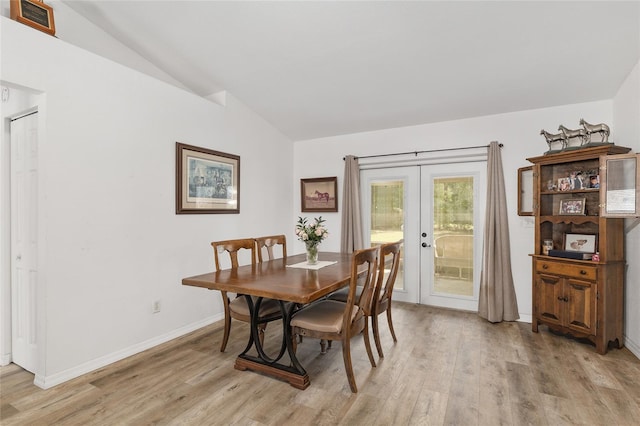 1601 NE 47th Ct, Ocala, FL 34470 - dining area featuring french doors, lofted ceiling, light wood finished floors, and baseboards