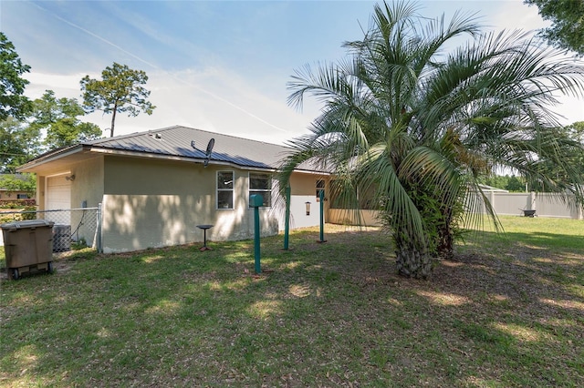 1601 NE 47th Ct, Ocala, FL 34470 - back of property with an attached garage, stucco siding, and metal roof