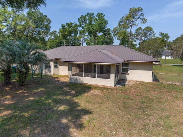 1601 NE 47th Ct, Ocala, FL 34470 - rear view of property featuring a sunroom and metal roof