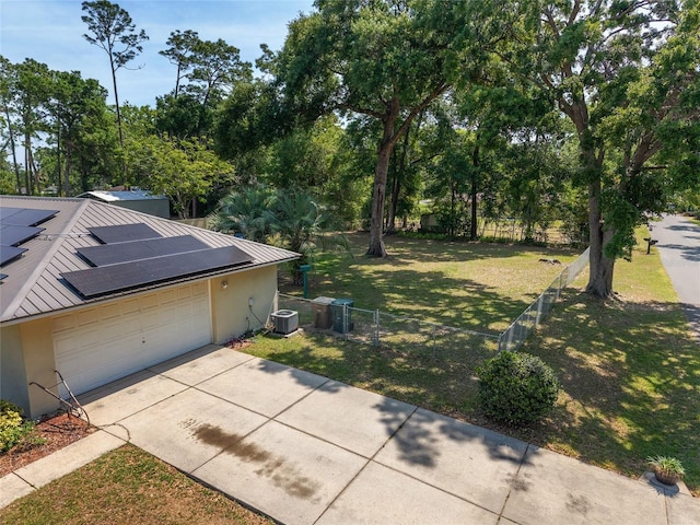 1601 NE 47th Ct, Ocala, FL 34470 - view of yard featuring central AC unit, driveway, and an attached garage
