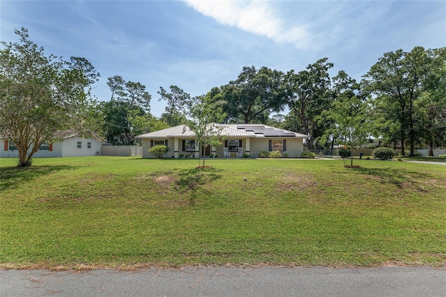 1601 NE 47th Ct, Ocala, FL 34470 - single story home featuring roof mounted solar panels and stucco siding